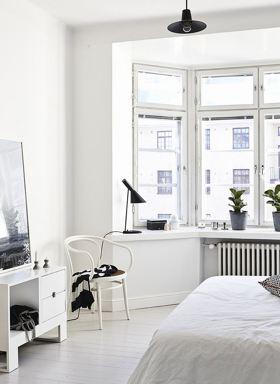 Beautiful bedroom in white with ample natural light streaming through