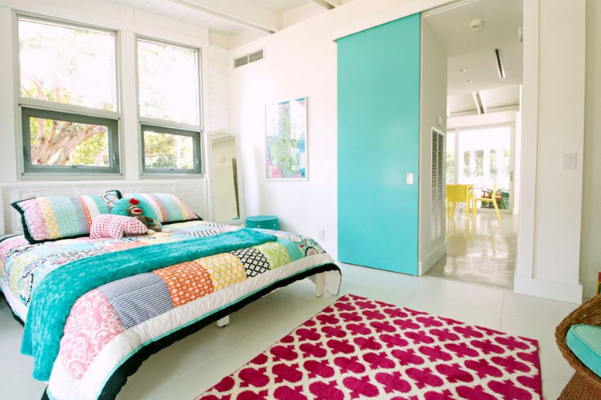 Bright turquoise door in a modern eclectic bedroom