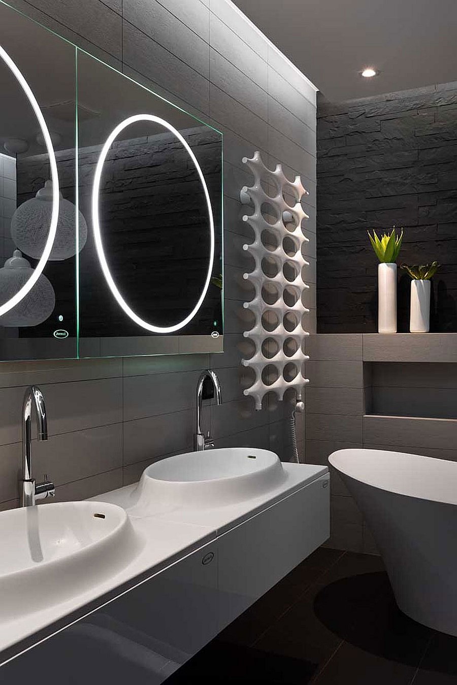 Brilliantly lit contemporary bathroom with unique mirrors and vanity
