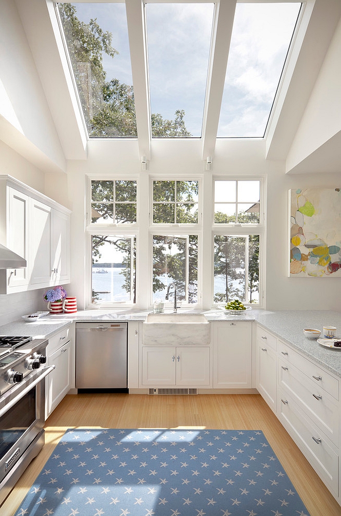 Contemporary kitchen in white opens up towards the view outside