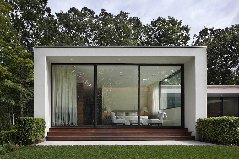 Contemporary silhouette of the home stands out in the forest backdrop