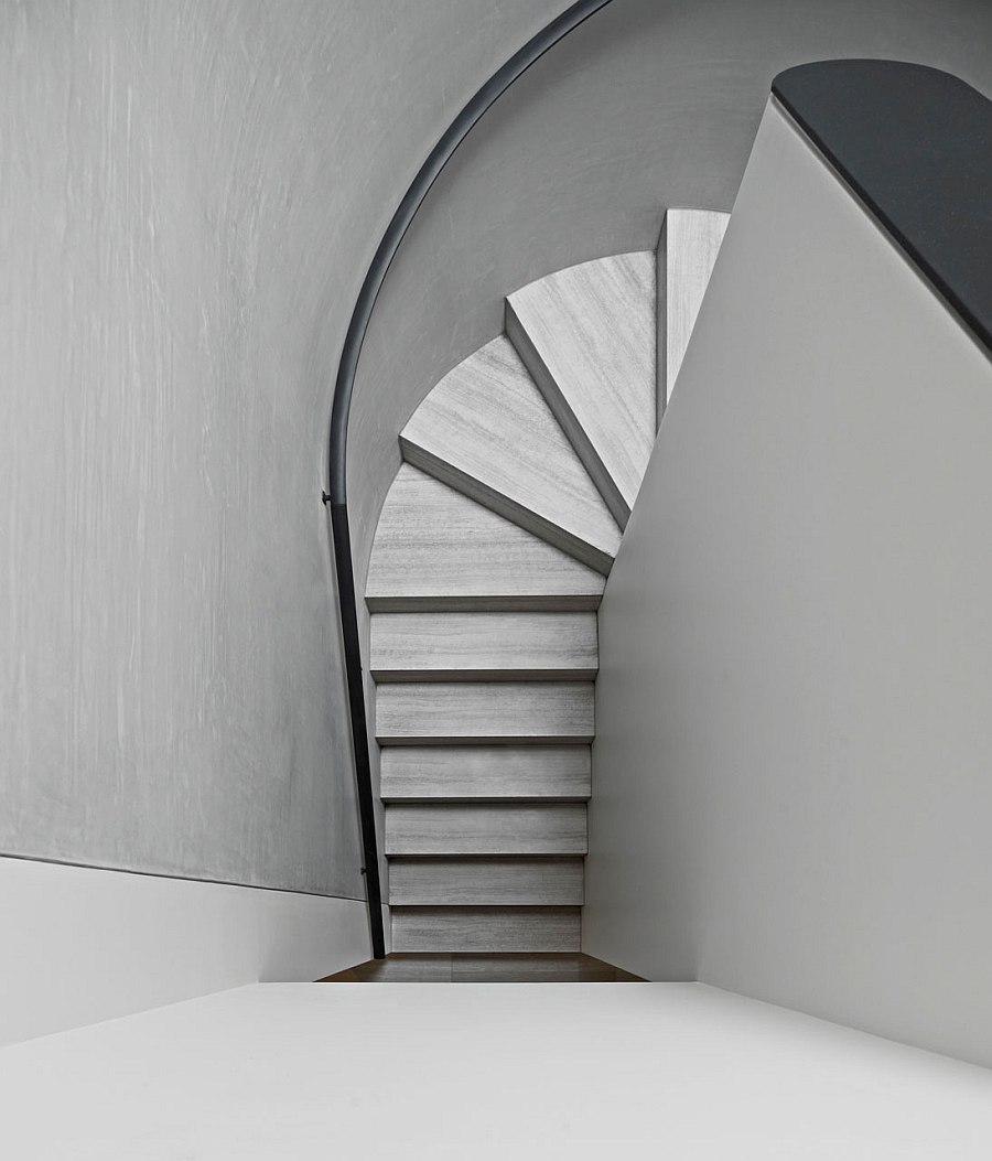 Curving staircase stands in contrast with simple, rectilinear form of the house