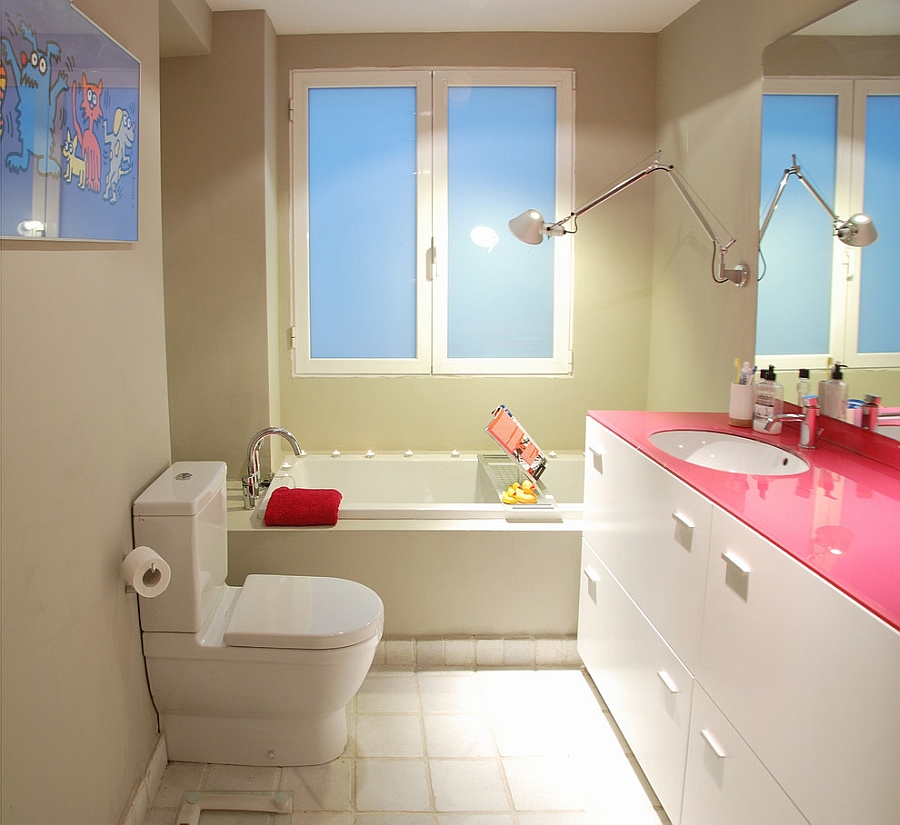 Custom fuchsia glass top adds aura of hot pink to the bathroom