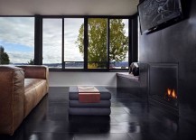 Dark-living-area-with-fireplace-exudes-sleek-sophistication-217x155