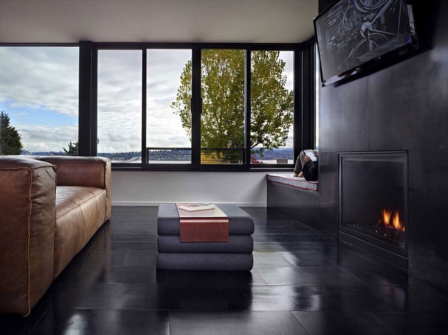 Dark living area with fireplace exudes sleek sophistication