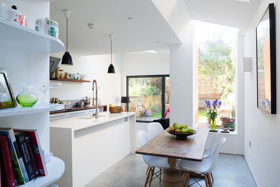 Dark pendant lights stand out thanks to the white kitchen backdrop