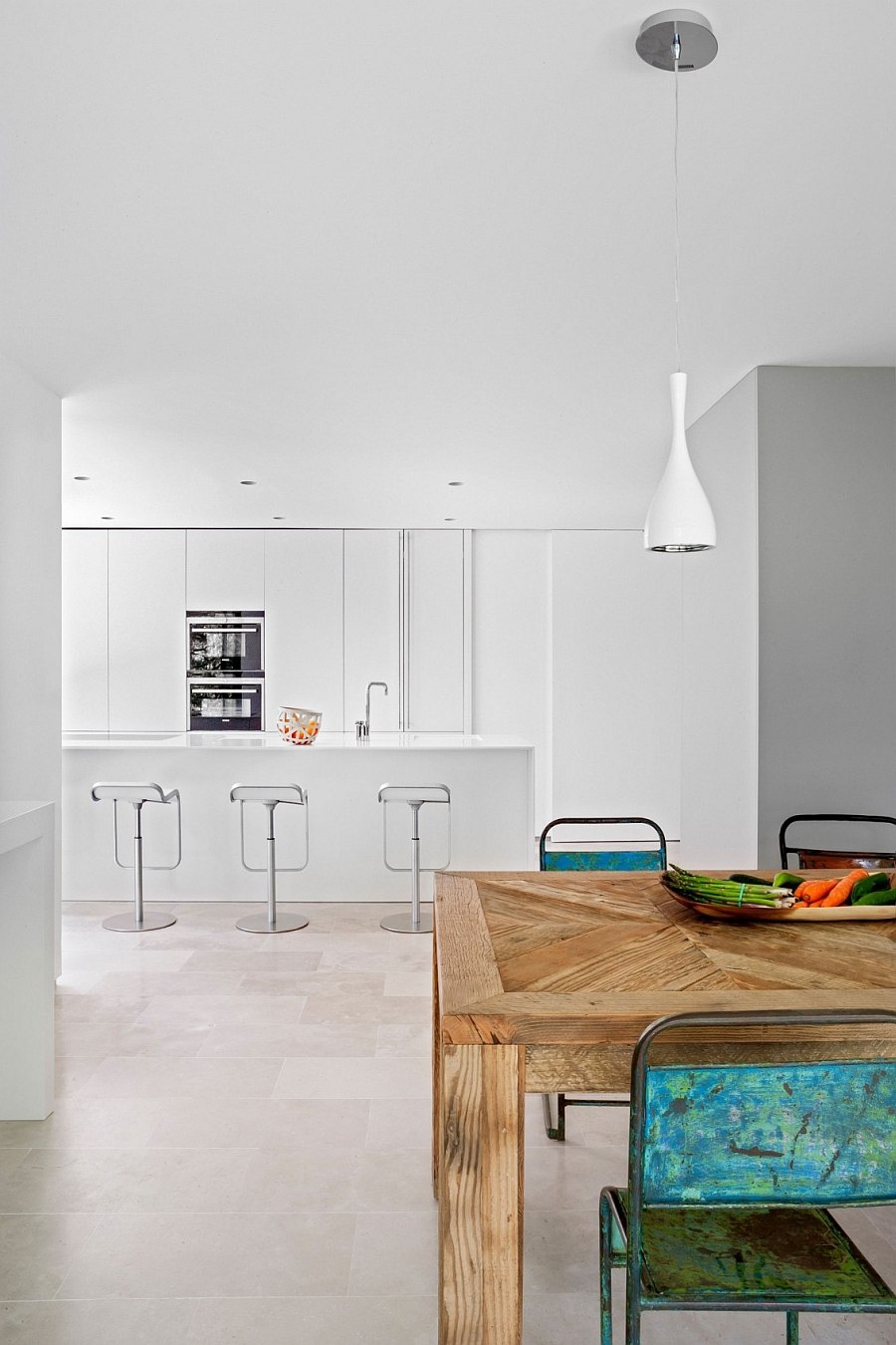 Dining table and chairs add a hint of rustic charm to the modern home