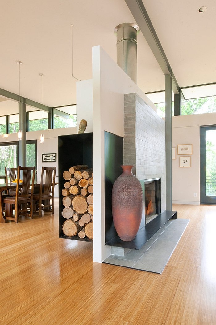 Fireplace and floating wood storage unit separate the living and dining rooms [Design: McInturff Architects]