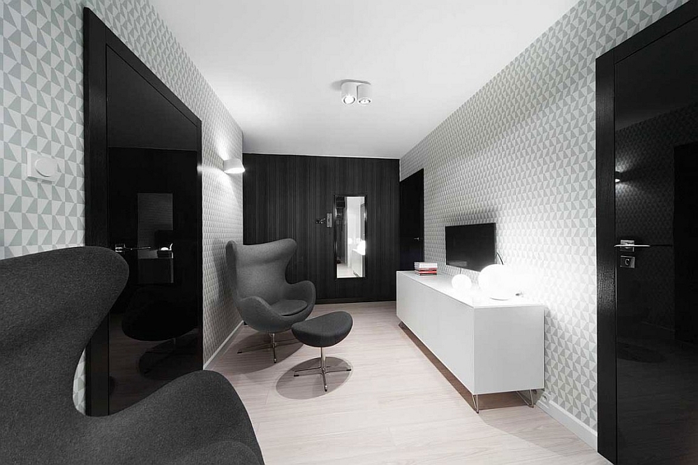 Geometric 3D wallpaper adds a layer of intrigue to the monochromatic apartment