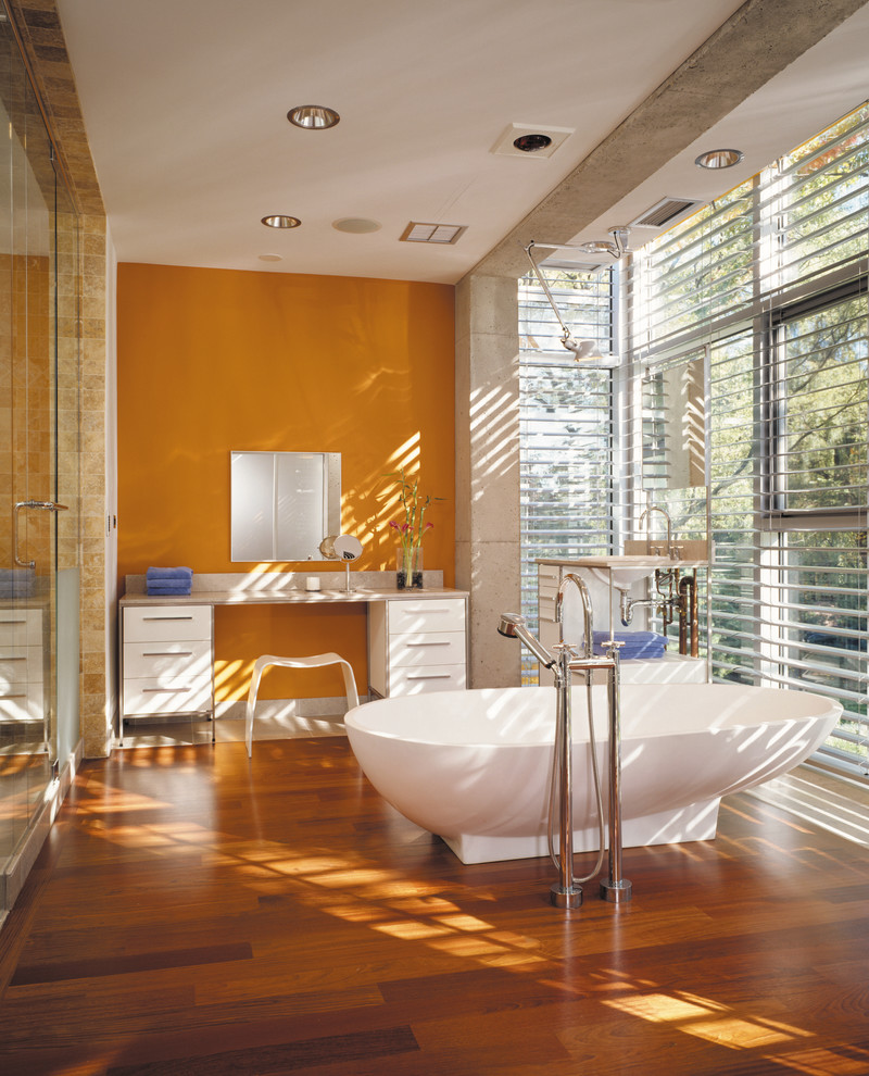 Industrial style bathroom with a dash of orange [Design: Thomas Roszak Architecture]