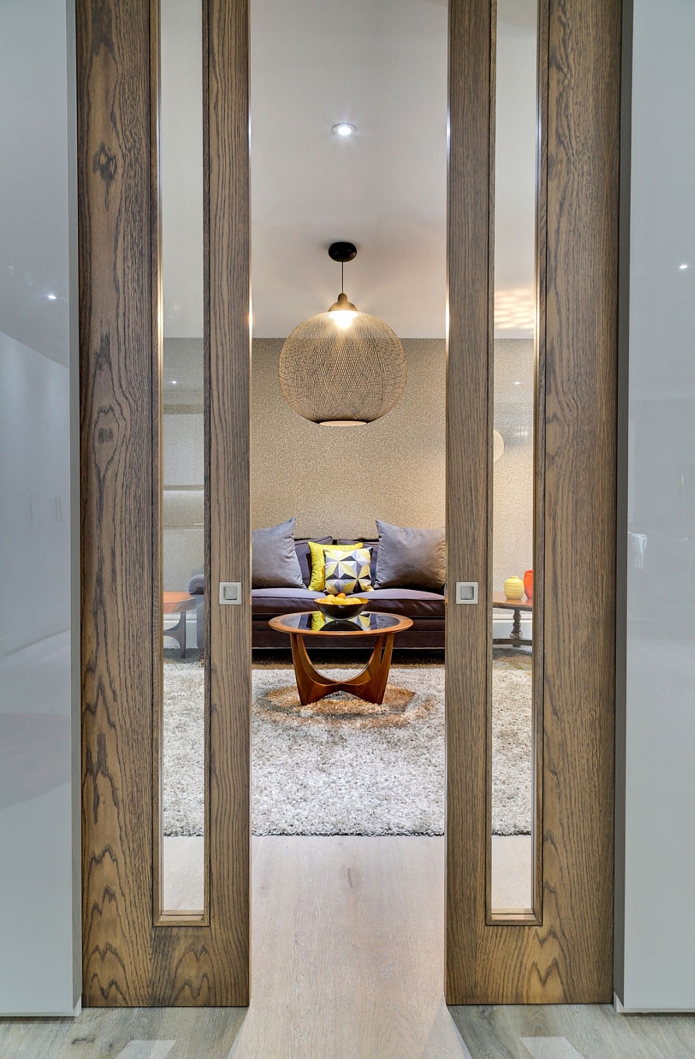 Living room with brilliant globe pendant and sliding wooden framed doors