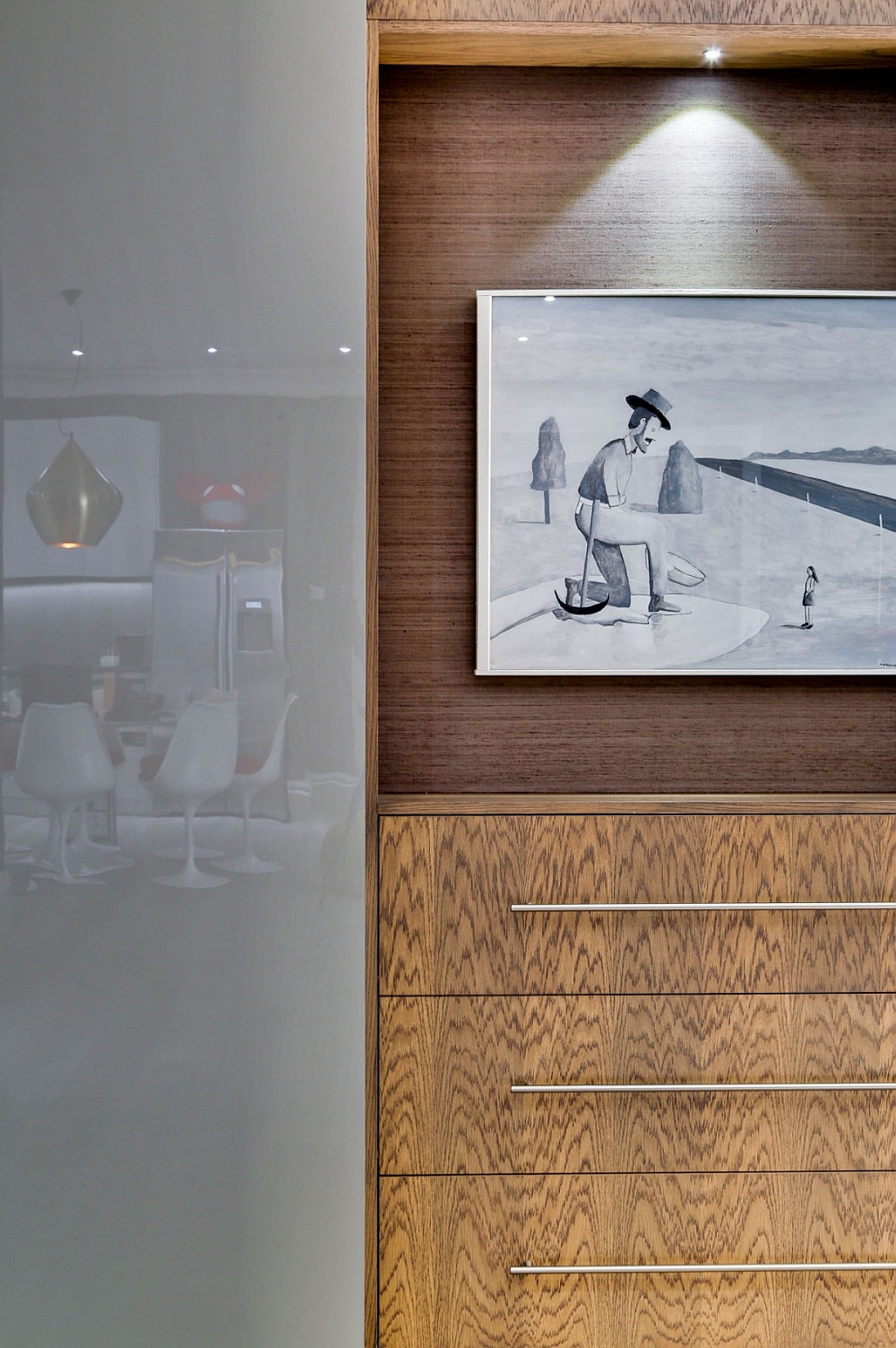 Lovely artwork and wooden divider storage add visual contrast to the posh bachelor pad