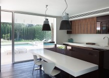 Low-kitchen-volume-that-is-connected-with-the-pool-area-outside-217x155