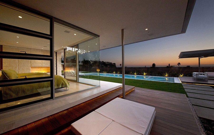 Master bedroom with glass walls overlooking the pool and the ocean