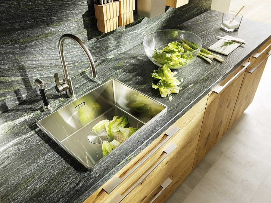 Natural stone countertop and backsplash bring visual contrast to the kitchen