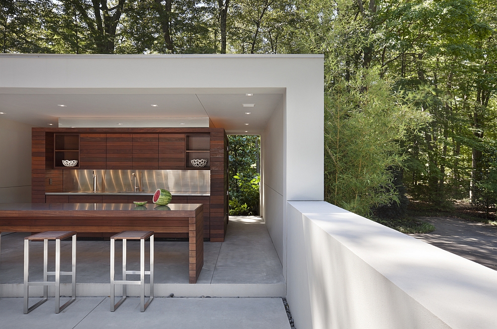 Pool house of the contemporary home with its own kitchen and barbecue area