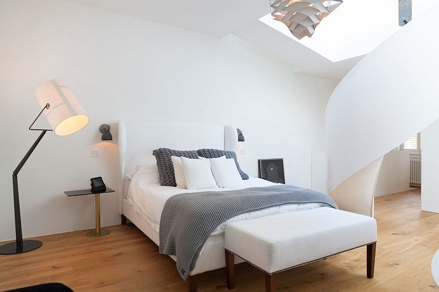 Relaxing master bedroom in white with a spiral staircase to the mezzanine level