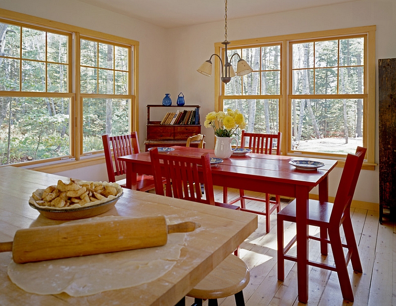 Rustic dining room with red table and chairs