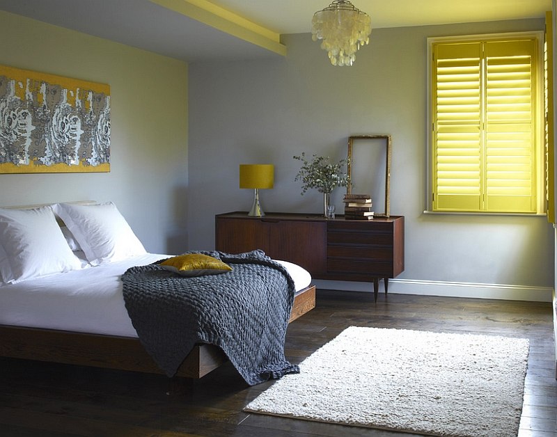 Shutters add cheerful yellow glow to the bedroom [Design: Weatherwell Elite - Aluminum Shutters]