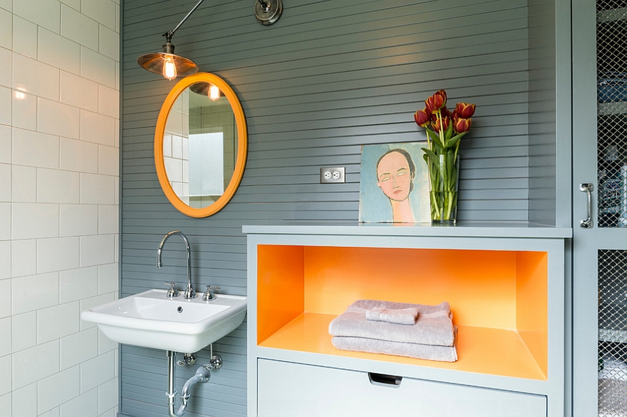 Simple orange additions can infuse energy into the dull bathroom [Design: J.A.S. Design-Build]