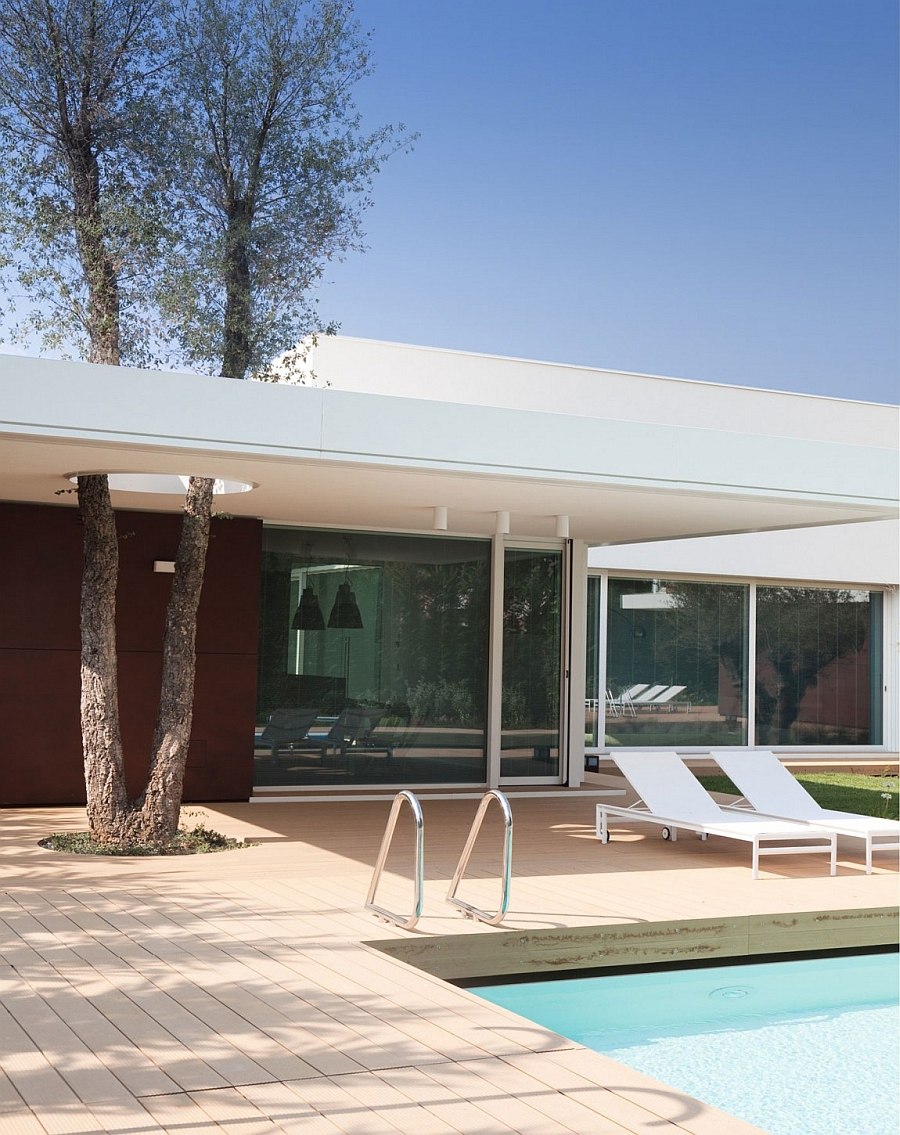 Sliding glass doors connect the interior with the pool area