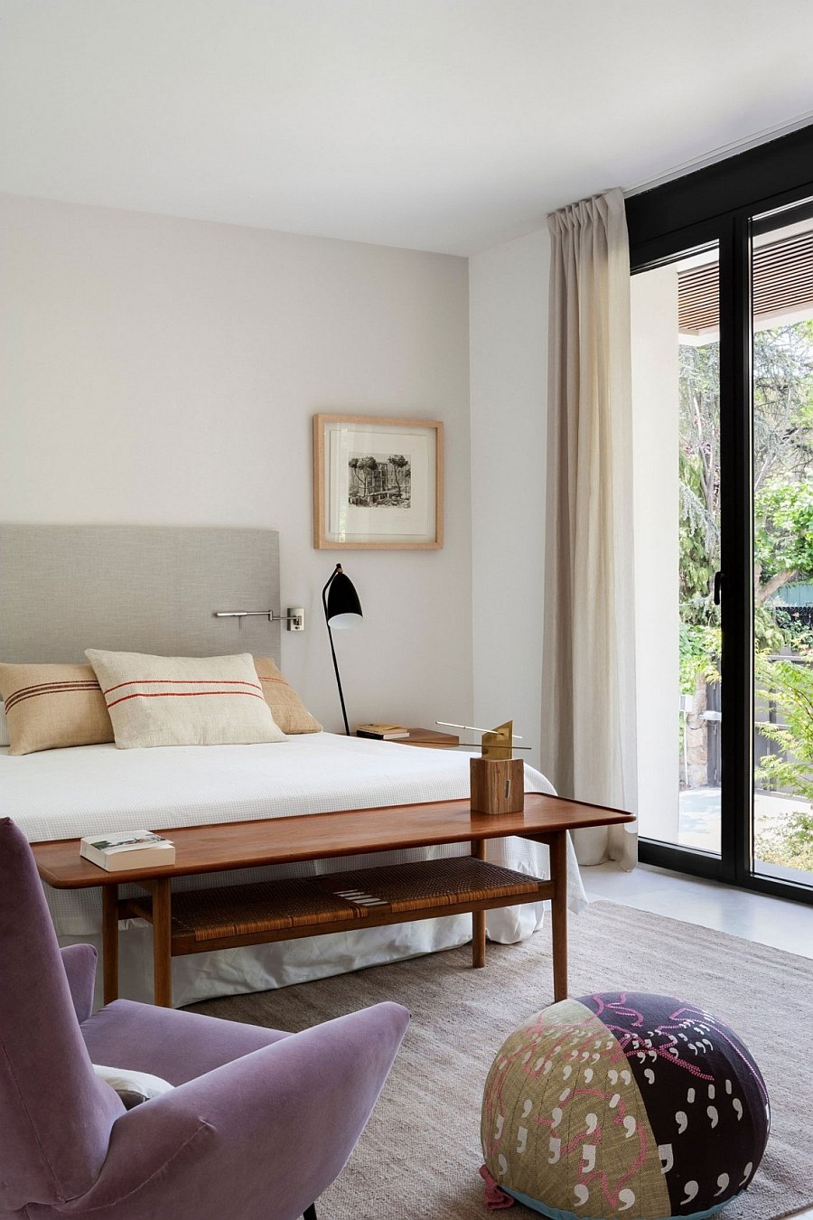 Small bedroom in white with a splash of purple