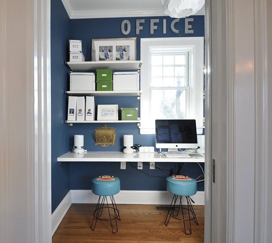 Small home office design with sleek shelves in white and a blue backdrop