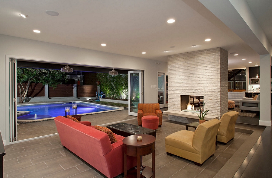 Stackable glass doors connect the living room with the pool