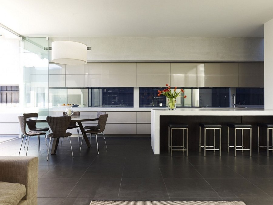 Sunken level holds the kitchen and dining space connected with the pool area outside