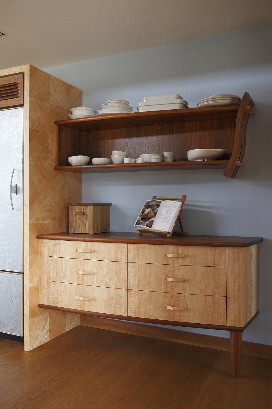 Traditional dresser next to the fridge gives the space a warm, cozy appeal