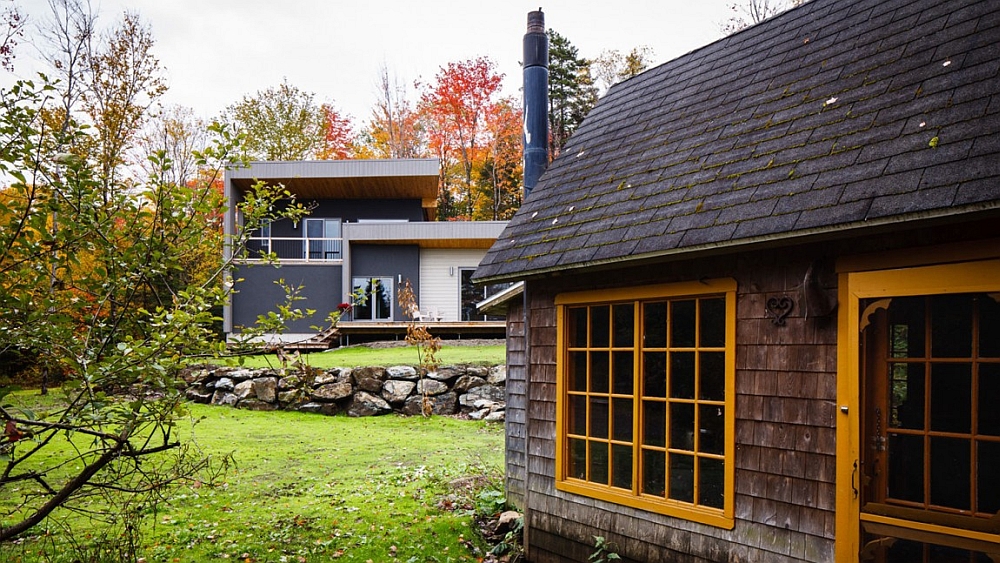 Twin structures and an old stone wall give the home rustic charm