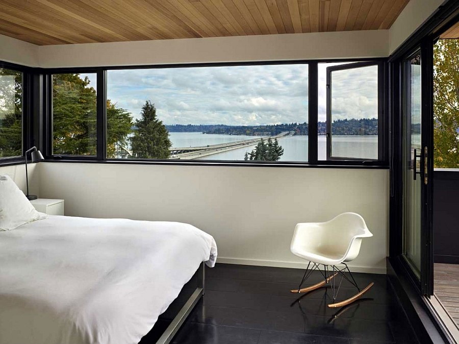 View of the lake in the distance from the cozy, modern bedroom