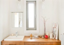 White-bathroom-with-black-floor-tiles-and-wooden-vanity-217x155