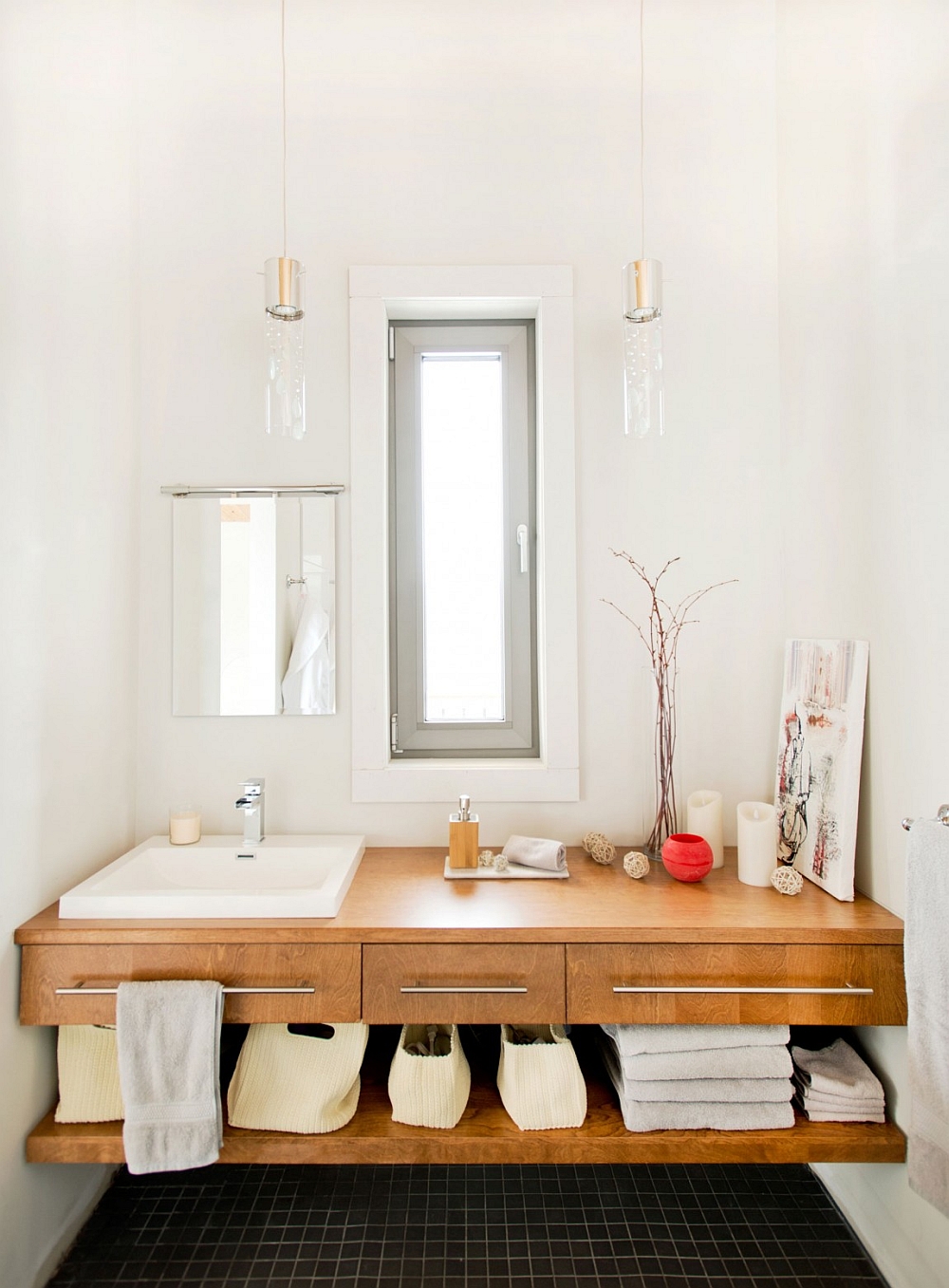 White bathroom with black floor tiles and wooden vanity