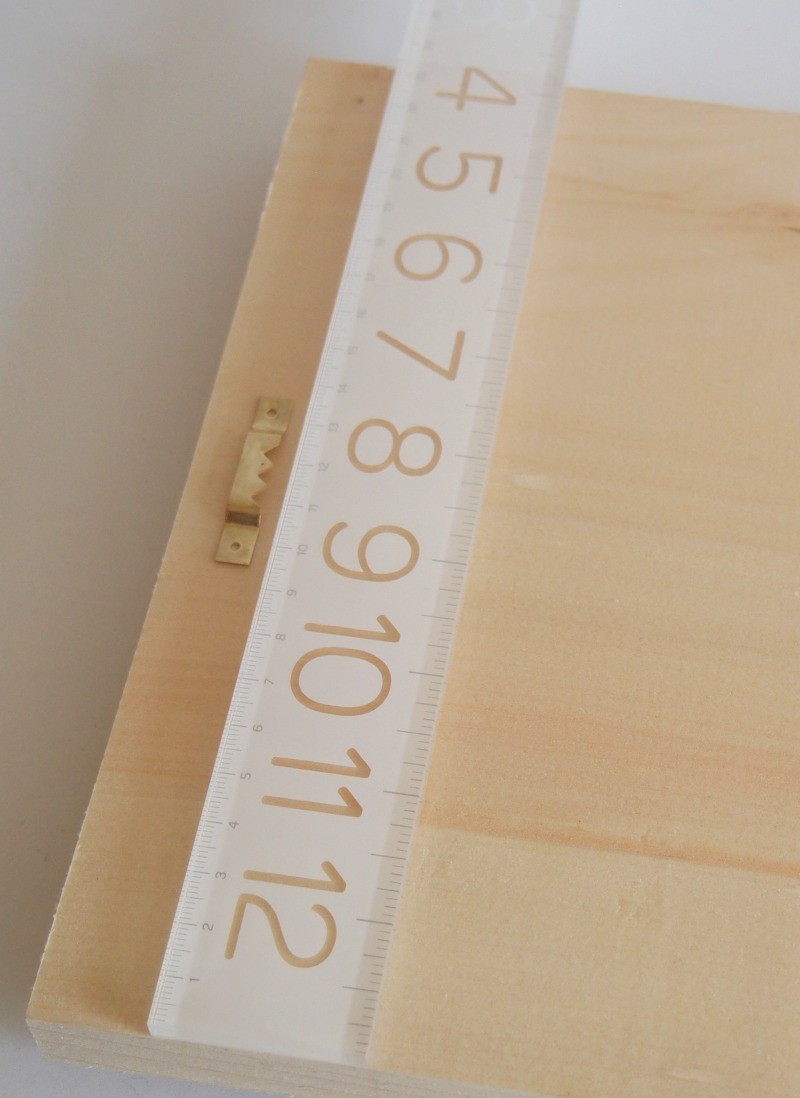 Measure the center of the board to hang it in style