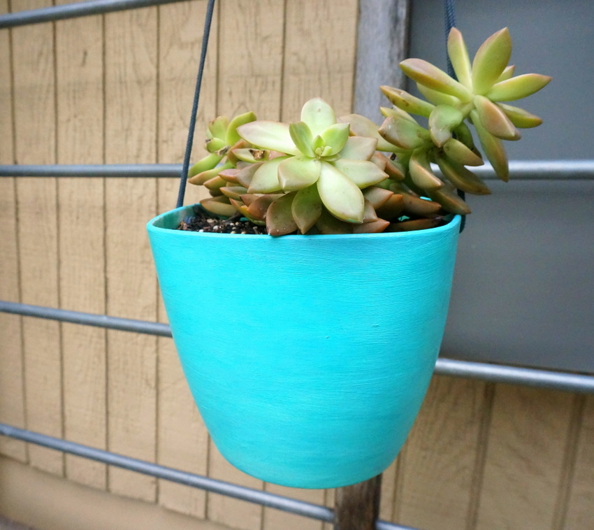 An aqua hanging planter