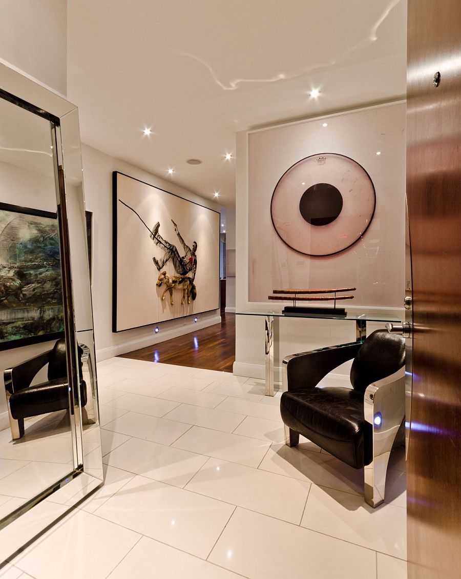 Brilliant art collection of the homeowner stands out visually in the hallway