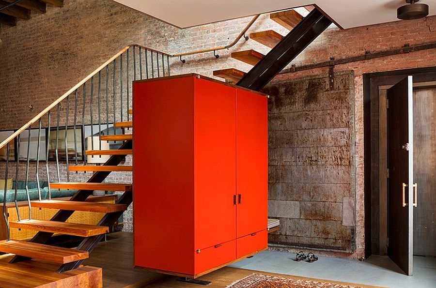 Brilliant orange cabinet becomes the statement piece in the living area