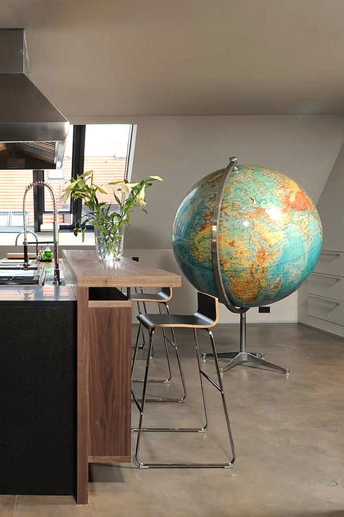 Giant globe in the kitchen stands out as an ingenious addition!