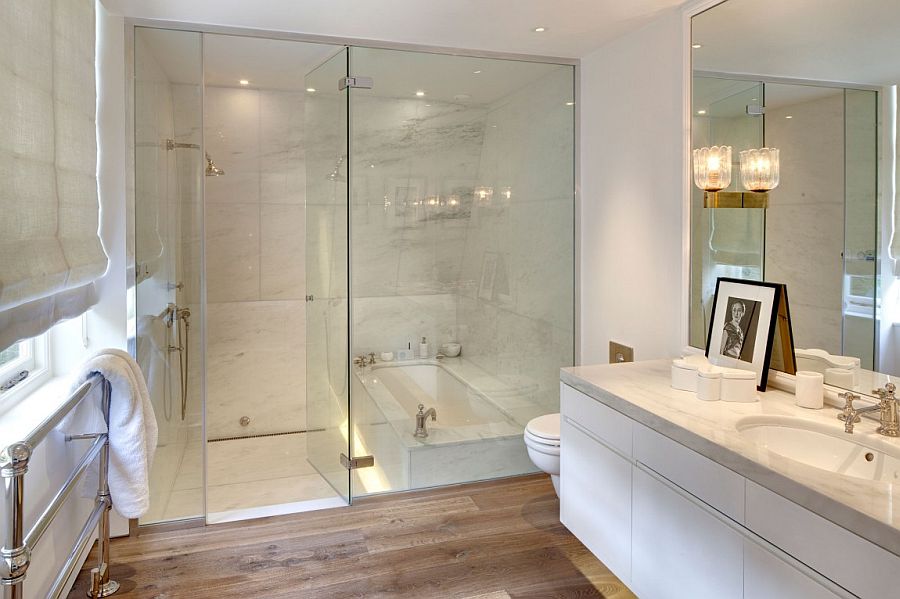 Glass shower enclosure in the traditional white bathroom