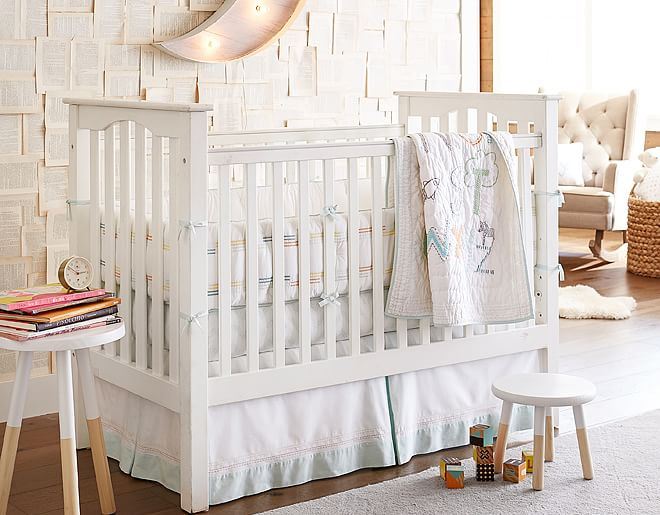 Hardwood flooring and a rug in a beautifully designed nursery