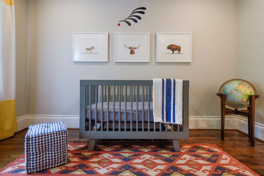 Hardwood flooring and an area rug in a modern nursery