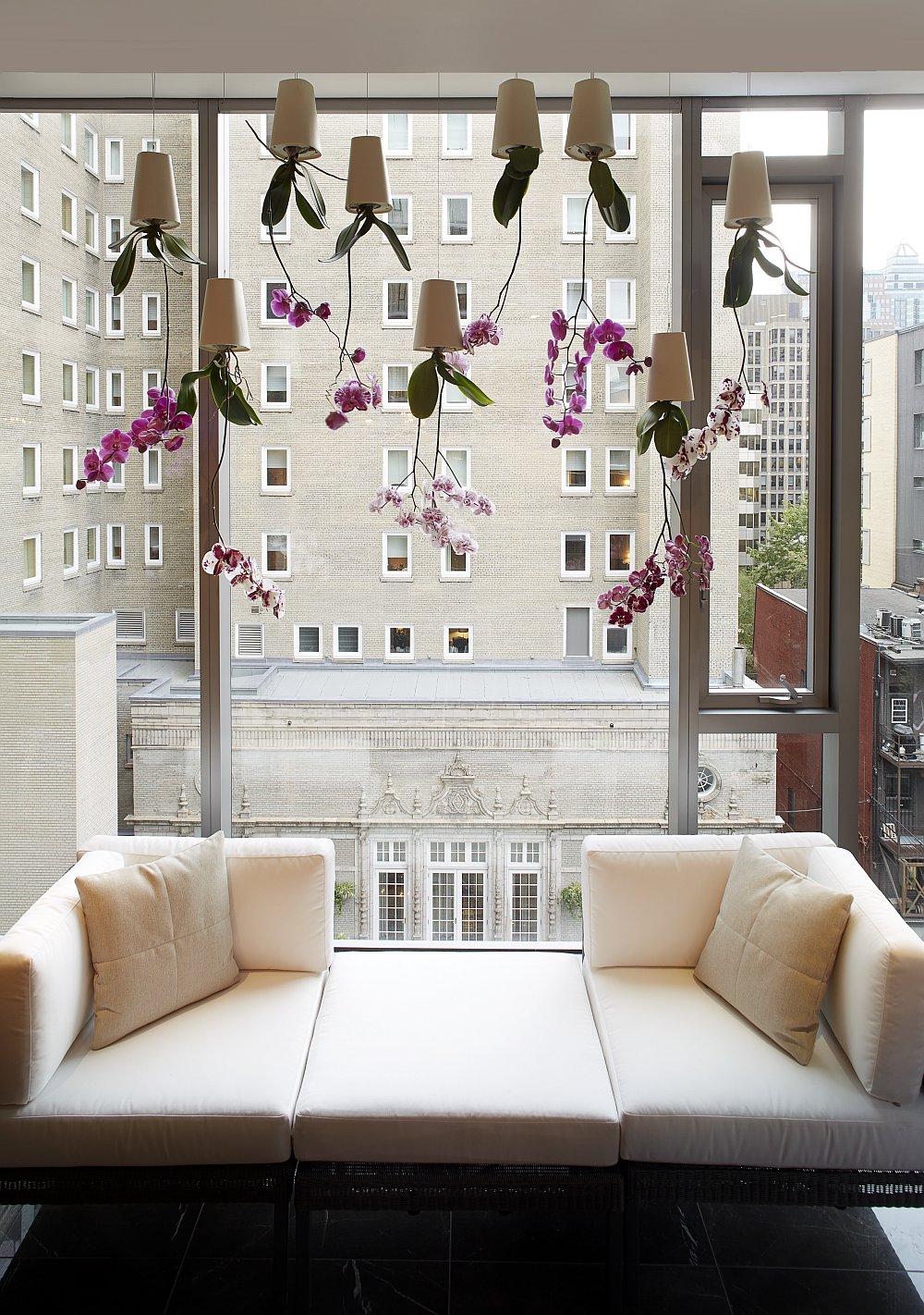 Large glass windows offer unabated views of the city skyline