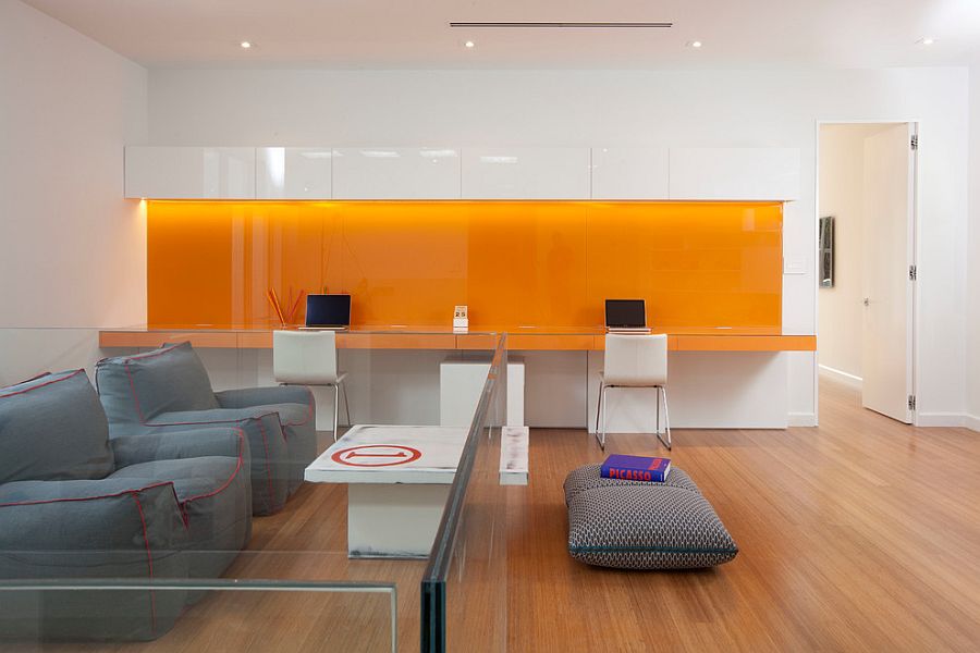 Orange backsplash and desk adds vibrant charm to the contemporary home office [Design: DKOR Interiors]