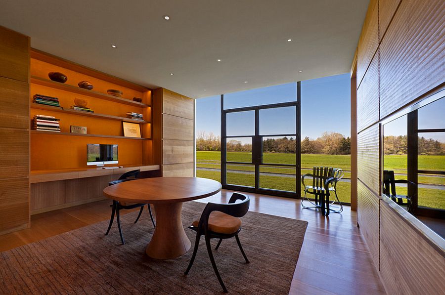 Orange in the room blends in with the warm wooden surfaces [Design: Vinci - Hamp Architects]