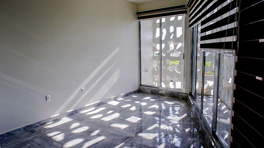 Perforated concrete screen brings in ventilation even while offering privacy