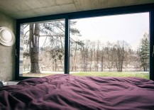 Plush-bedroom-of-the-home-with-concrete-walls-and-lovely-forest-view-217x155