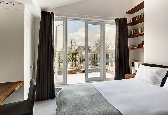 Plush bedroom with private balcony and view of the rear garden