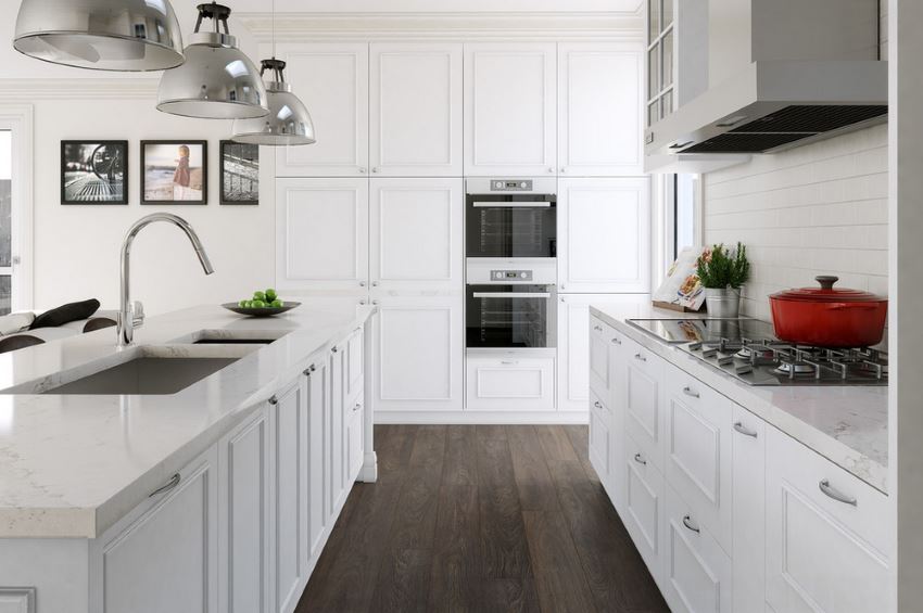 Red Le Creuset cookware in a white modern kitchen