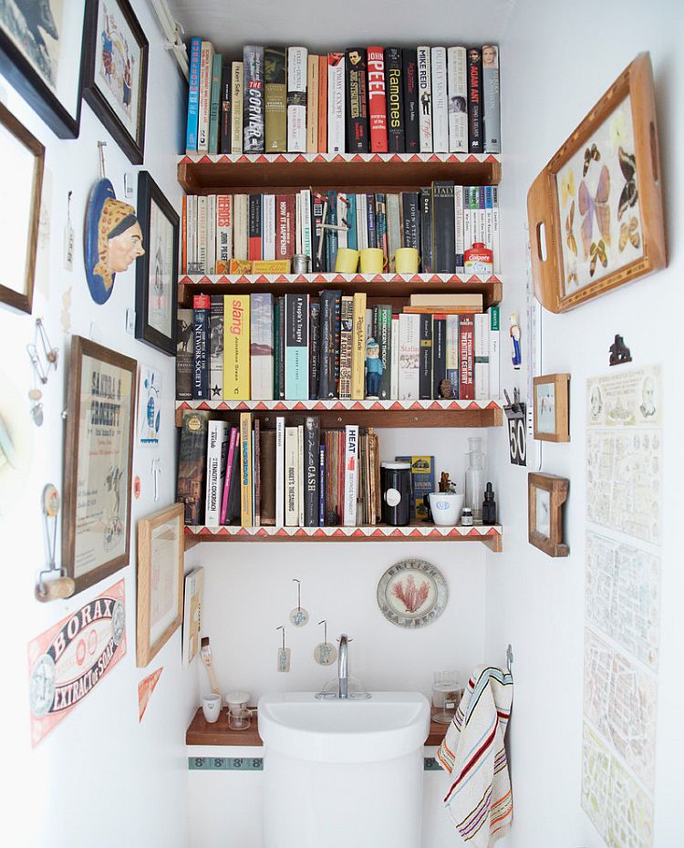 Shelves of the eclectic powder room are decked out with books [Design: Joanna Thornhill Interiors]